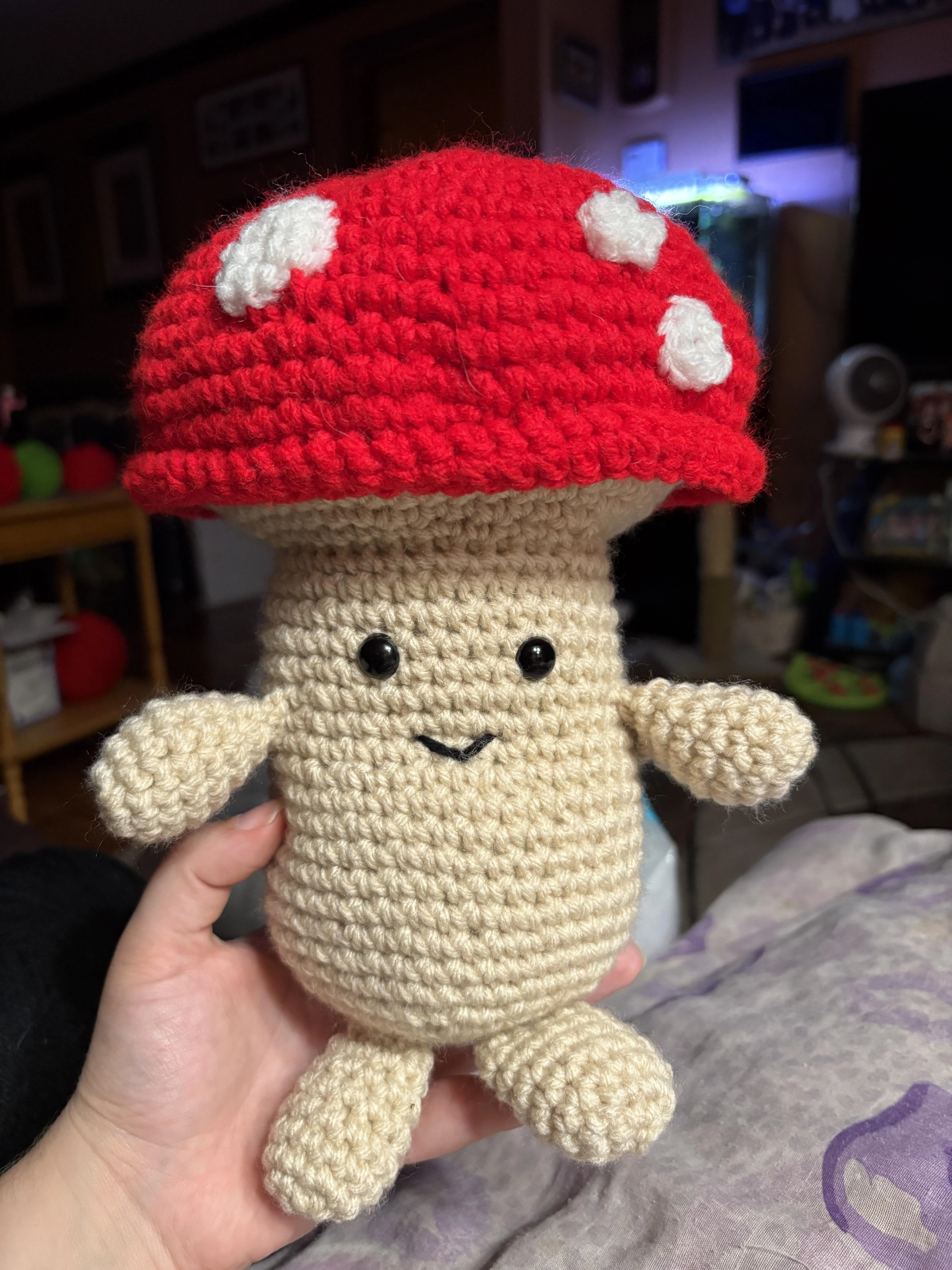A red toadstool mushroom guy with eyes, arms and legs